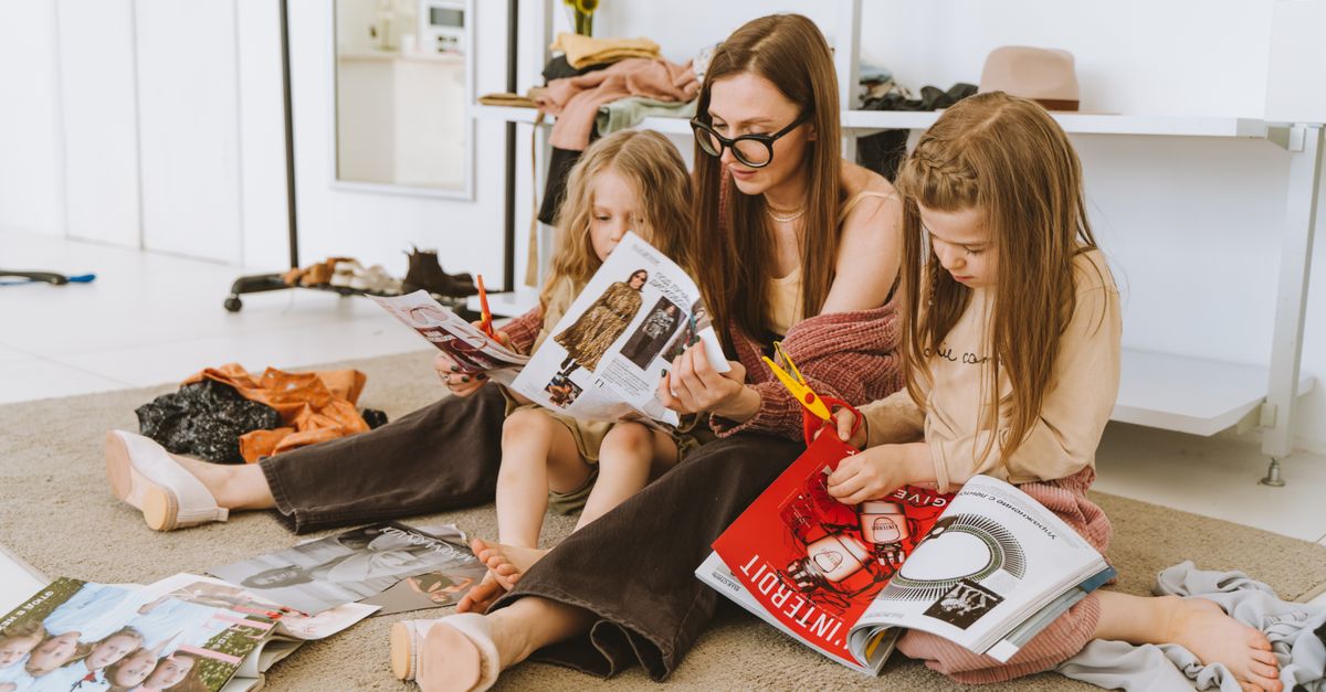 A mother and her daughters enjoying a creative day with magazines at home.
